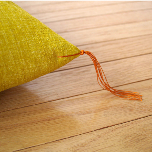 The corner tassel stitches on a zabuton cushion are called sumifusa. It does not only function as a decoration, but it is also a traditional technique used to make sure that the cotton filling does not come out from the corners of the cushion. 