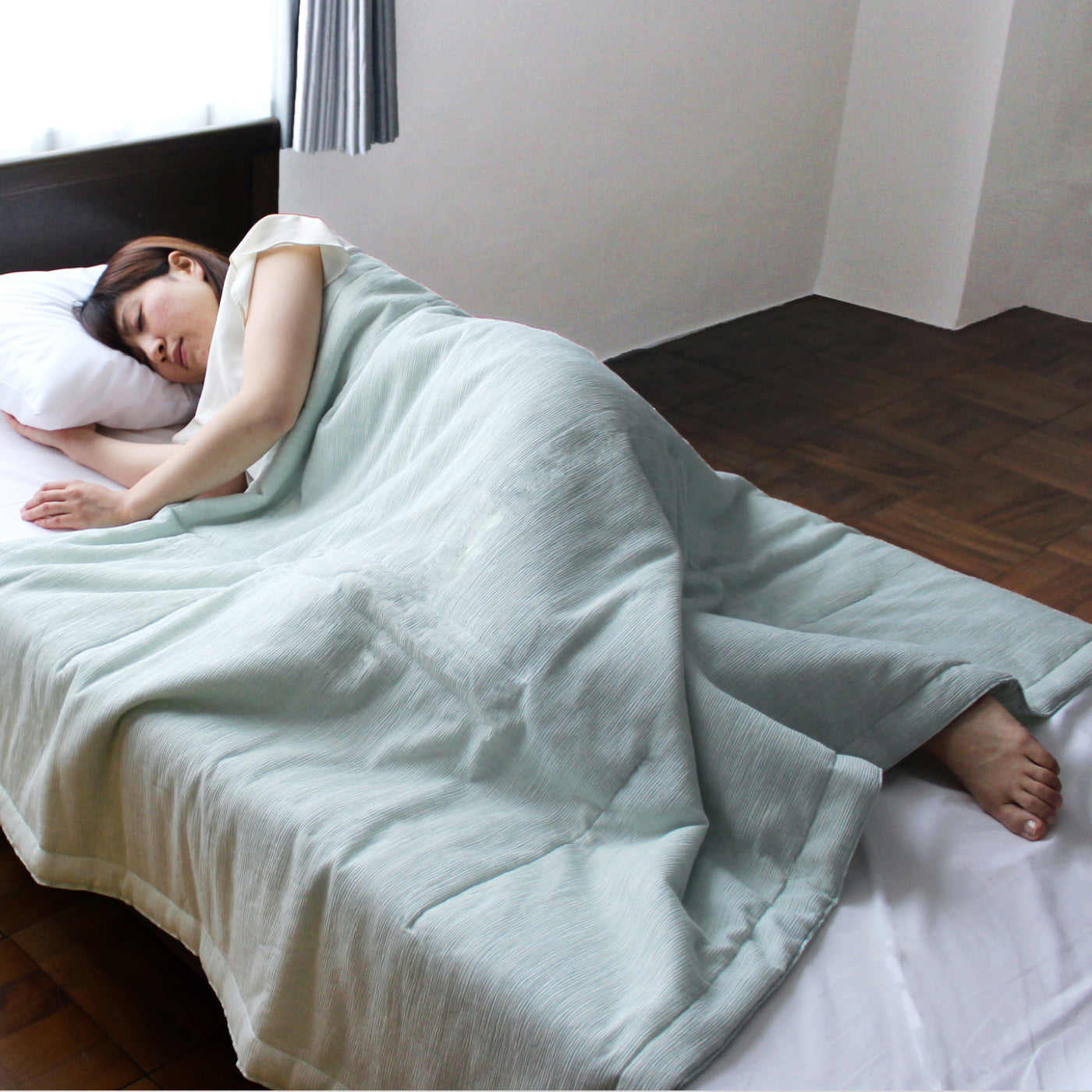 To sleep comfortably during this hot summer, we Japanese think to make our futon smaller (120 x 160 cm) than the regular size. Due to its size, we can put our arms and legs out from the futon to keep our body cooler, but not make our belly cooler by covering it with a futon.