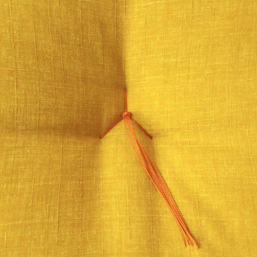 The three-pronged stitch on the top of a zabuton, known as “toji,” has the function of keeping thecotton evenly distributed. Most zabuton use a “toji” in the shape of a cross, but Kyoto zabuton usethe three-pronged stitch shown the picture.