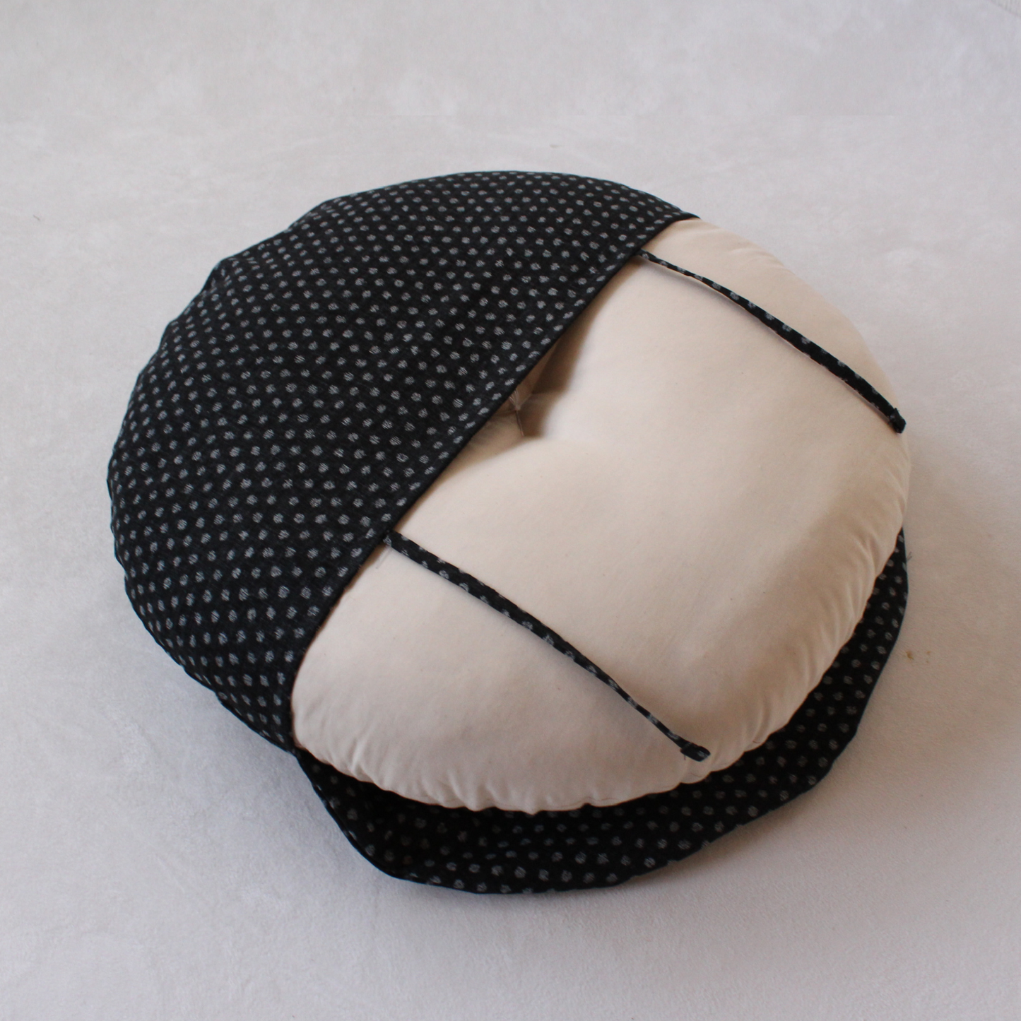 The cover features a slip-on design with an overlapping back, secured by tie closures.