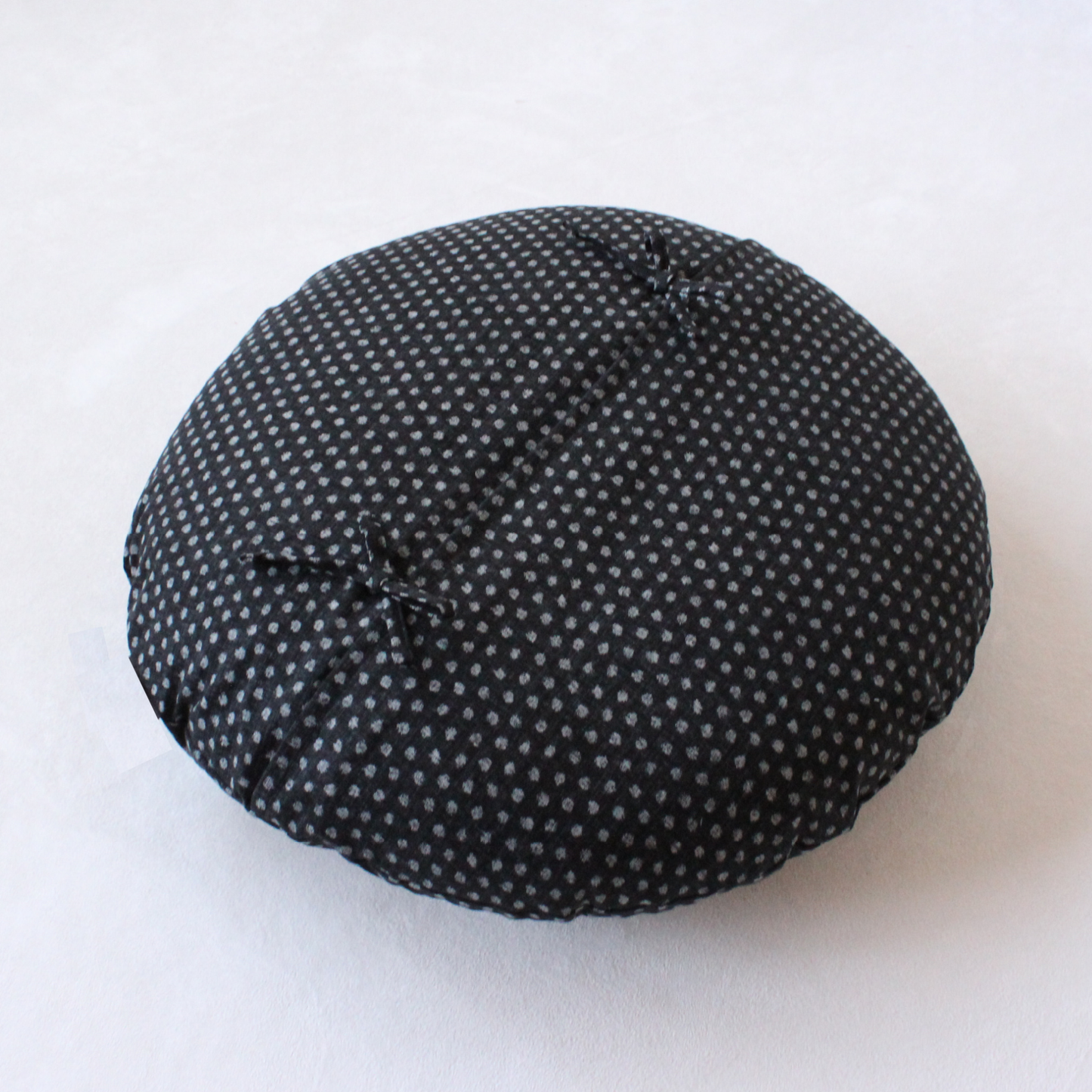 The cover features a slip-on design with an overlapping back, secured by tie closures.